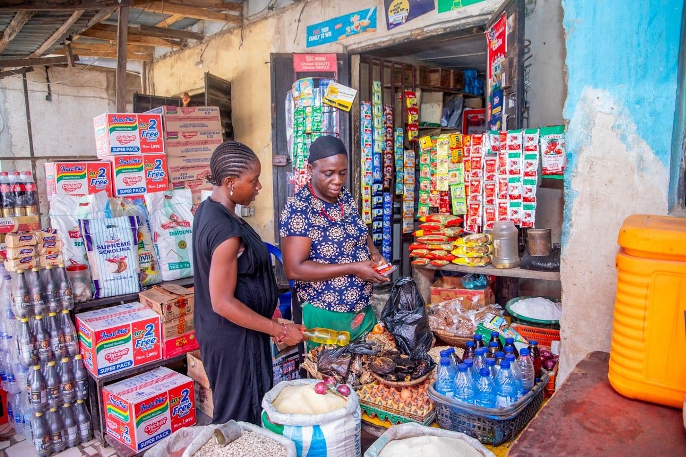 TMF beneficiary shopping for food at a local vendor's shop